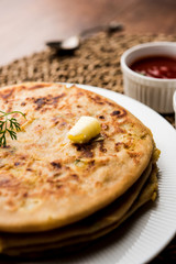 Aloo Paratha / Indian Potato stuffed Flatbread. Served with fresh curd and tomato ketchup. selective focus