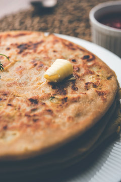 Aloo Paratha / Indian Potato stuffed Flatbread. Served with fresh curd and tomato ketchup. selective focus