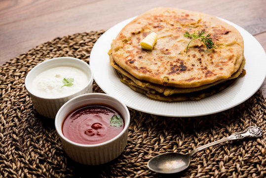 Aloo Paratha / Indian Potato stuffed Flatbread. Served with fresh curd and tomato ketchup. selective focus