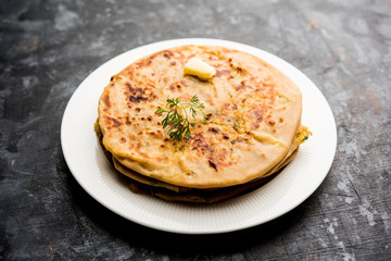 Aloo Paratha / Indian Potato stuffed Flatbread. Served with fresh curd and tomato ketchup. selective focus