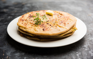 Aloo Paratha / Indian Potato stuffed Flatbread. Served with fresh curd and tomato ketchup. selective focus