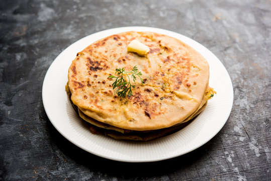 Aloo Paratha / Indian Potato stuffed Flatbread. Served with fresh curd and tomato ketchup. selective focus