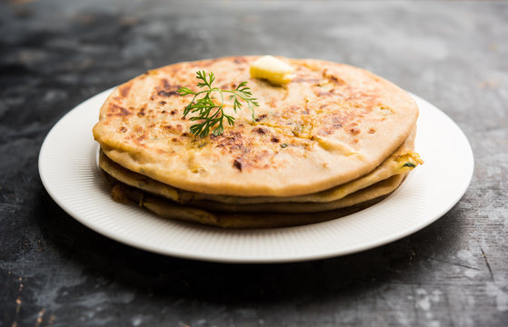 Aloo Paratha / Indian Potato stuffed Flatbread. Served with fresh curd and tomato ketchup. selective focus