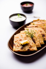 Aloo Paratha / Indian Potato stuffed Flatbread. Served with fresh curd and tomato ketchup. selective focus