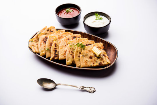 Aloo Paratha / Indian Potato stuffed Flatbread. Served with fresh curd and tomato ketchup. selective focus