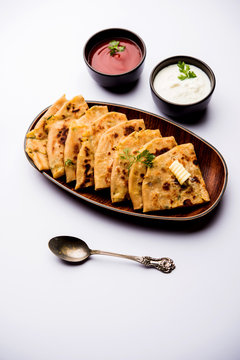 Aloo Paratha / Indian Potato stuffed Flatbread. Served with fresh curd and tomato ketchup. selective focus