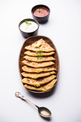Aloo Paratha / Indian Potato stuffed Flatbread. Served with fresh curd and tomato ketchup. selective focus