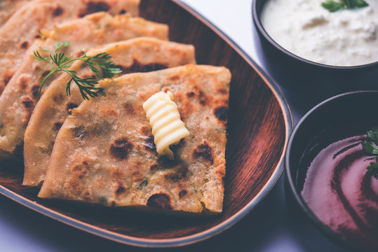 Aloo Paratha / Indian Potato stuffed Flatbread. Served with fresh curd and tomato ketchup. selective focus