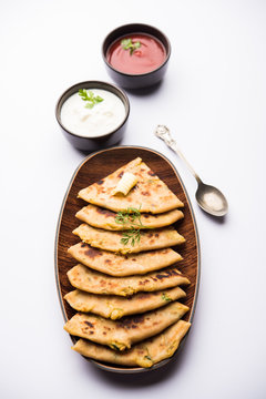 Aloo Paratha / Indian Potato stuffed Flatbread. Served with fresh curd and tomato ketchup. selective focus
