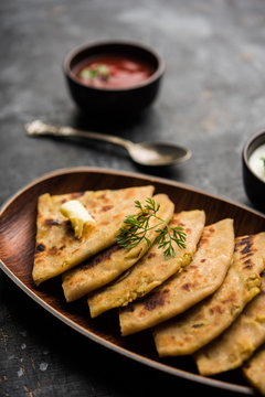 Aloo Paratha / Indian Potato stuffed Flatbread. Served with fresh curd and tomato ketchup. selective focus