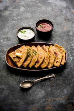 Aloo Paratha / Indian Potato stuffed Flatbread. Served with fresh curd and tomato ketchup. selective focus
