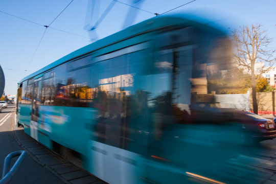 The motion of a blurred streetcar in the daytime.