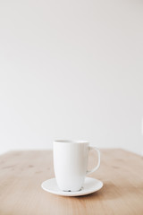 Cup of coffee on clean wooden table. Flat lay, top view.