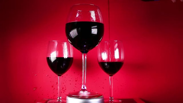 Red wine in glass on colorful background