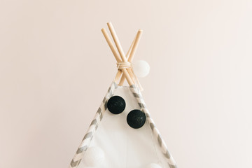 Interior room for a child. Tent for game. Wigwam with a garland of cotton balls. White and grey © ksyusha_yanovich