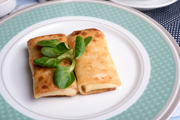 Traditional russian breakfast - rolled pancakes with sweet cottage cheese