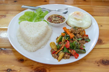 Stir fried basil leaf pork with rice and put the preserved egg.