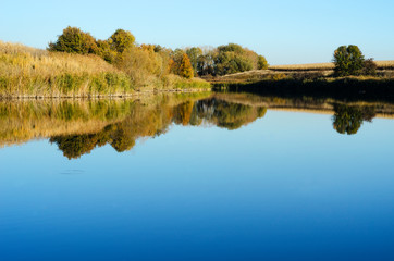 Naklejka na ściany i meble quiet pond with reflection of the shore 3