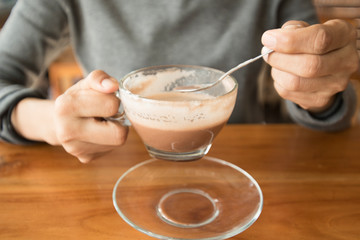 hands holding hot cup of coffee or tea