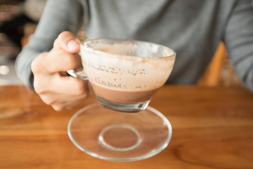 hands holding hot cup of coffee or tea