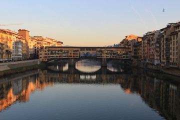 Fototapeta premium Sunset view of Ponte Vecchio over Arno River in Florence, Italy. 
