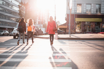 People walk in streets of at sunset