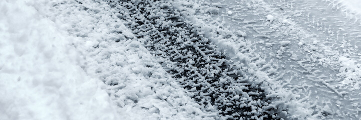 Winter Driving Background - snowy road with tire tracks 