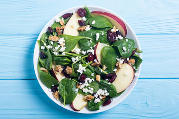 Autumn spinach salad with apple , cheese , walnut and dried cranberry