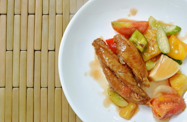 deep fried fish in sweet and sour gravy sauce on white plate