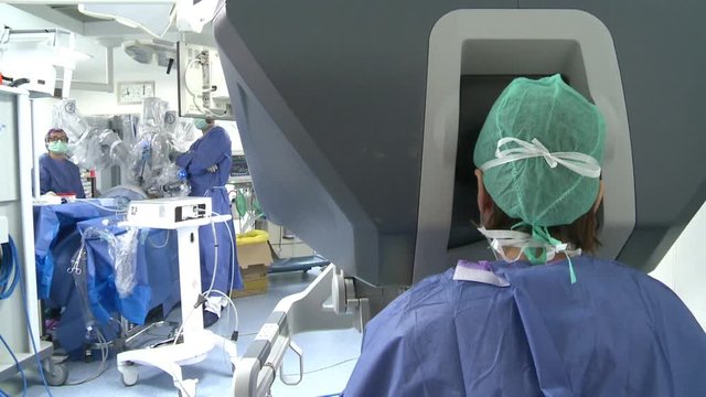 The doctor uses a slow - visual surgical robot of the back
Surgery room