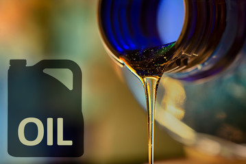 Low oil problem and liquid stream of motorcycle motor oil flows from the neck of the bottle...