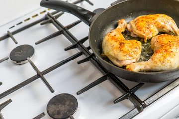 Fry chicken legs in a pan with spices.