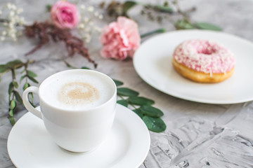 Cup with cappuccino, delicious doughnut, morning concept, bakery, fast carbs