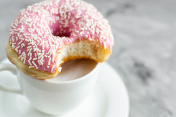Cup with cappuccino, delicious doughnut, morning concept, bakery, fast carbs
