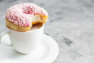 Cup with cappuccino, delicious doughnut, morning concept, bakery, fast carbs