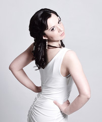 Fototapeta premium young woman model in white evening dress posing