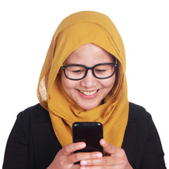 Muslim Woman Smiling While Reading Message on Smart Phone