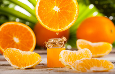 Orange Essential Oil on green leaves background