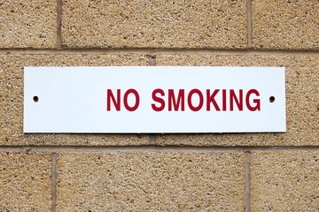 Written No Smoking sign on outside wall