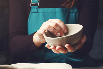 woman potter at work, making pottery, ceramic workshop, traditional craft