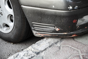 Damaged front car bumper with scratches