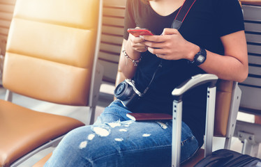 Woman sitting on seat at airport