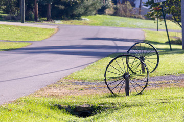 Wagon wheels beside a driveway