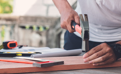 Carpenter man hammering a nail