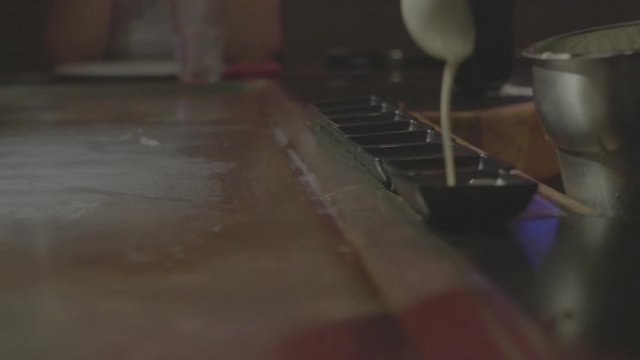 4k slow motion clip of  hibachi cook serving sauce in small containers