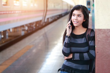 young traveler woman with backpack using smart phone during traveling on holiday