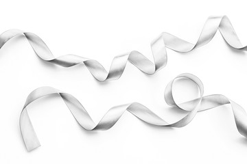 Silver satin ribbon in bright white pearl gray color isolated on white background with clipping path
