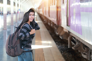 young traveler woman with backpack waiting for train