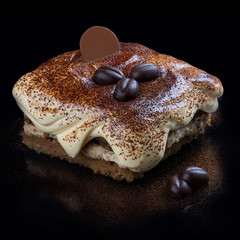 Italian tiramisu dessert  on a black background