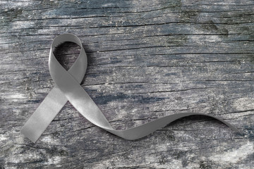 Brain cancer awareness with grey color ribbon on old aged wood isolated with clipping path: